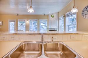 a kitchen with a sink and a clock on the wall at Sunset 389 in Depoe Bay +66 photos
