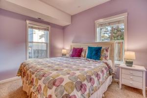 a bedroom with a bed and two windows at Sunset 389 in Depoe Bay