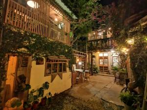 a courtyard of a building with a table and chairs at Dear B&B in Anping