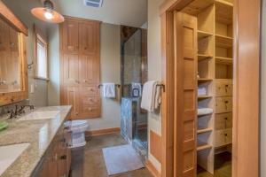 a bathroom with a shower and a toilet and a sink at The Davenport - Meredith Lodging in Bend +44 photos