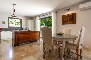 a kitchen and dining room with a table and chairs at La Verdière - Contemporary house with garden and private pool in LʼIsle-sur-la-Sorgue