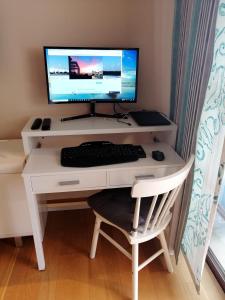 a white desk with a computer monitor and a chair at Dream View in Adeje