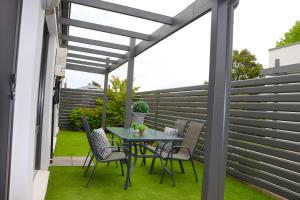 
a patio area with a table and chairs at 16 King Street in Myrtleford
