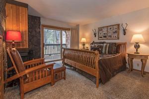 a bedroom with a bed and a chair and a window at Wildflower 61 in Sunriver