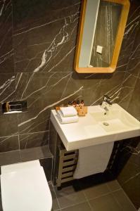 a bathroom with a sink and a mirror at Squatters Run Apartments in Thredbo +35 photos