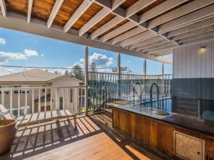 a large deck with a view of the pool and a deck at SeaCrest in Yamba