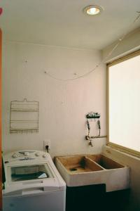 a kitchen with a sink and a stove at Saint Martin Apartments in Guadalajara