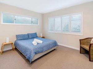 ein Schlafzimmer mit einem Bett und einem Fenster in der Unterkunft Seagrass House in Yamba