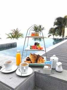 
a table topped with plates of food and drinks at Aleenta Resort and Spa, Hua Hin - Pranburi SHA Plus in Pran Buri
