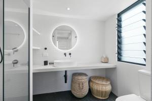 a bathroom with a sink and a mirror at Oceanbreeze - Sunshine Beach Ocean Views in Sunshine Beach
