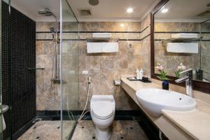a bathroom with a toilet and a sink and a shower at Scent Premium Hotel in Hanoi