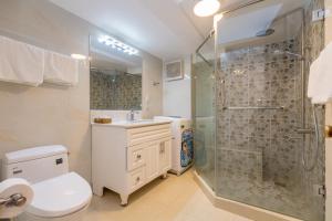 a bathroom with a shower and a toilet and a sink at Homestay coco in Vung Tau