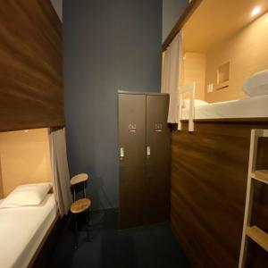 a small room with a bed and bunk beds at Hotel The Gate Kumamoto in Kumamoto