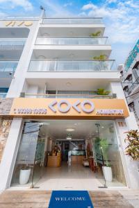 a store front of a building with a welcome sign at Homestay coco in Vung Tau