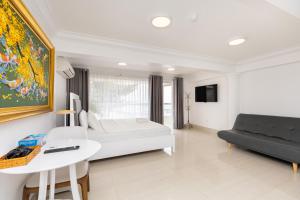 a bedroom with a bed and a table and a couch at Homestay coco in Vung Tau