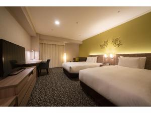 Postel nebo postele na pokoji v ubytování Hotel Associa Toyohashi