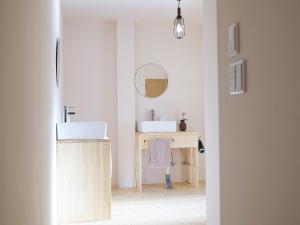 a bathroom with two sinks and a desk with a mirror at Guest House Kadoyasu in Kanazawa