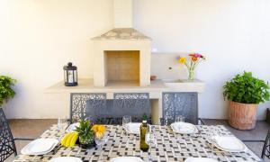 a dining room with a table and a fireplace at Villa Green Garden in Splitska