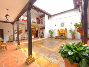 an indoor courtyard with a fireplace in a house at Casa del Carmen - Villa de Leyva in Villa de Leyva