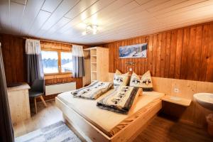 a bedroom with a bed and a sink in it at Haus Deule in Sankt Gallenkirch