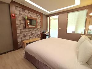 Postel nebo postele na pokoji v ubytování Jin Yong Quan Spa Hotspring Resort