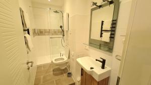 a white bathroom with a sink and a toilet at City Apartment Alici in Füssen +34 photos