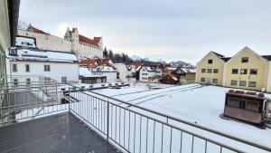 a city with snow on the roofs of buildings at City Apartment Alici in Füssen