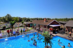 a group of people in a swimming pool at Hasle Camping & Hytter in Hasle