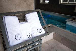 a basket of towels sitting next to a swimming pool at The Inn by Ilawu in Pietermaritzburg