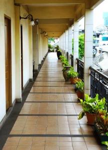 an empty hallway of a building with plants at Silom Village Inn in Bangkok