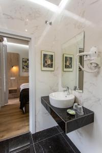 a bathroom with a sink and a mirror at Hostal Manuela by gaiarooms in Madrid