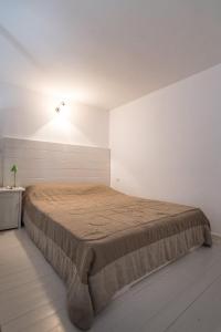 a bedroom with a large bed in a white room at DIMITRIOS in Skiros
