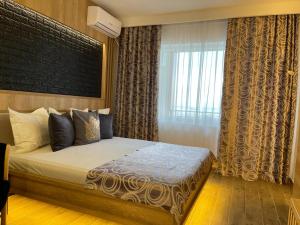 Postel nebo postele na pokoji v ubytování Hotel Tomis