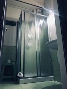 a shower with a glass door in a bathroom at Emme B&B in Messina