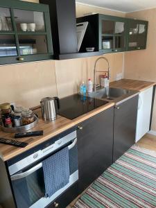 a kitchen with a sink and a stove at SoegaardensBB in Stenløse