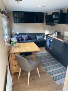 a small living room with a table and a couch at SoegaardensBB in Stenløse