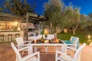 A garden outside Astarte Villas - Istar Villa with Tennis Court