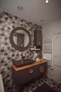 a bathroom with a sink and a mirror at Hotel Chicago in Shkodër