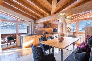 a kitchen and dining room with a table and chairs at Das Kaltenbach - ApartHotel in Kaltenbach