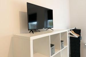 TV i/ili zabavni centar u objektu Moderne 3 Zimmer Ferienwohnung