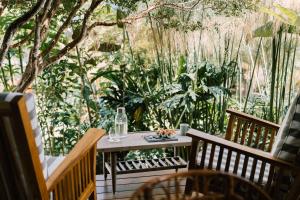 a table and chairs on a patio with trees at Casa 41 in Escazu