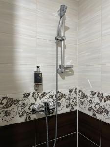 a shower with a blow dryer and a sink in a bathroom at Ubytovanie Zobor in Nitra
