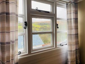 a window that is open with a view of the water at The Royal Oak Inn in Withypool