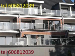 a large building with balconies on the side of it at Mrągowo Apartament Lake & Ski in Mrągowo