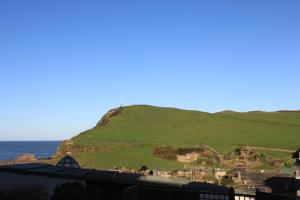 a hill with a monument on it next to the ocean at The Olive Branch in Ilfracombe
