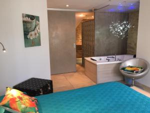 bagno con letto, vasca e lavandino di Les chambres du Vieux Bistrot a Cabrières-dʼAvignon