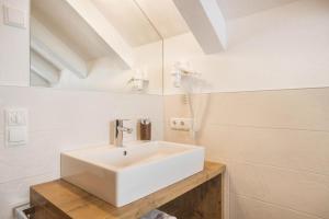a bathroom with a white sink in a room at Ciasa Funtanies Sas dla Crusc in San Martino in Badia