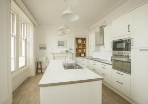 a kitchen with white cabinets and a white counter top at Linda Vista in North Berwick