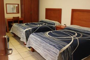 Postel nebo postele na pokoji v ubytování Hotel Marllou
