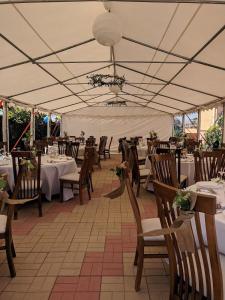 a dining area with tables and chairs in a tent at Casa Eden in Costinesti